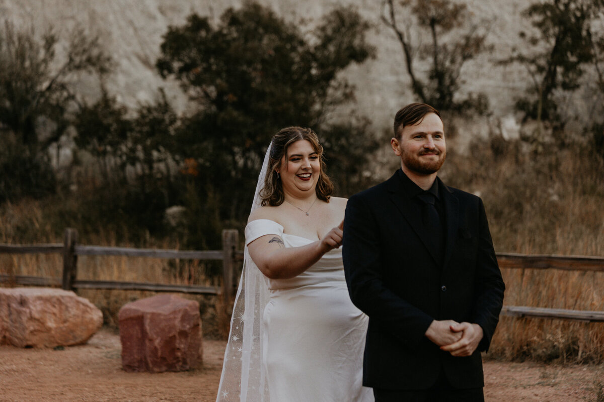 bride walking up behind her groom for their first look