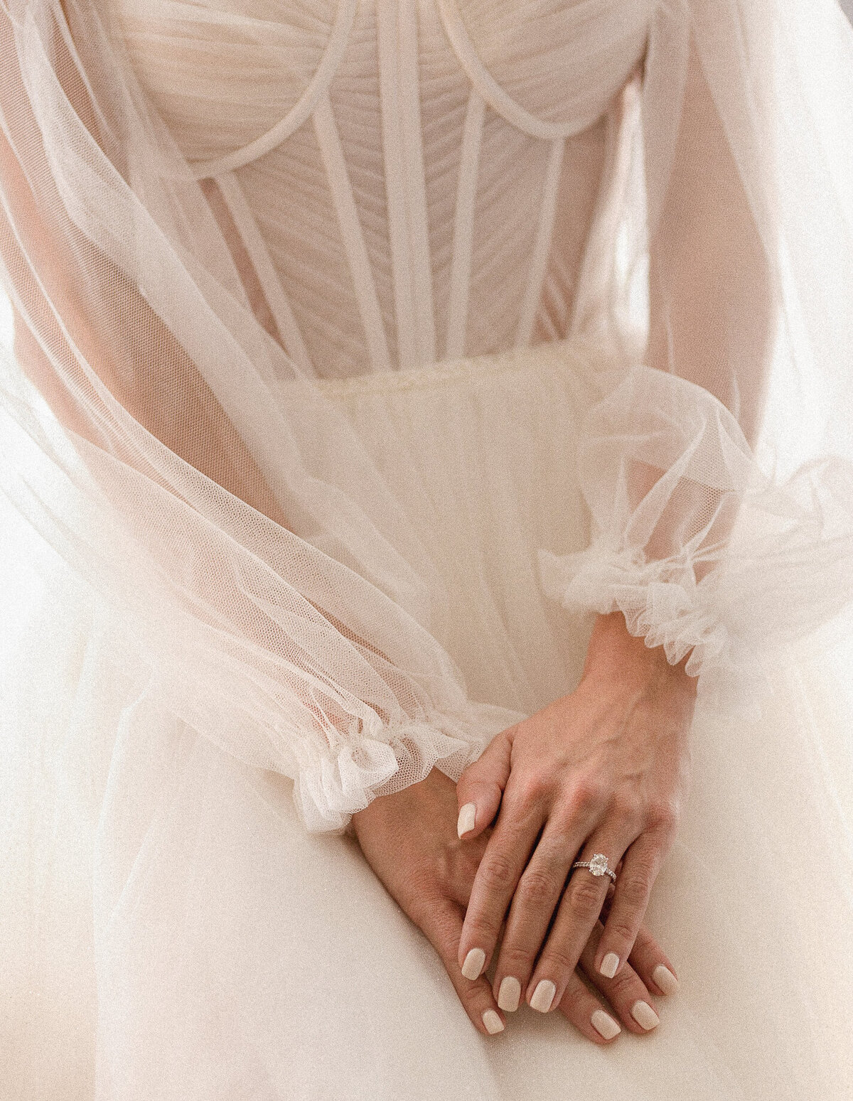 Close-up of bride's hands and dress details, photographed by Claudia Amalia, wedding photographer in South Florida.