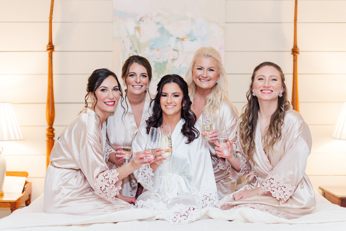 happy bride toasting with bridesmaids