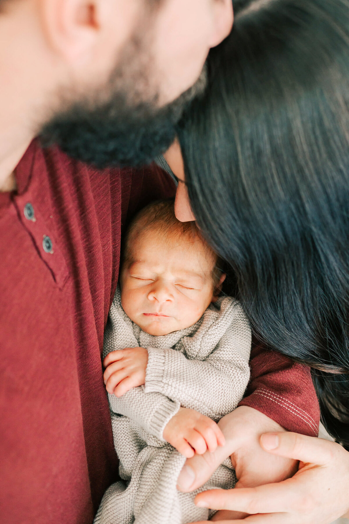 newborn baby kissed by parents during newborn photography in Branson