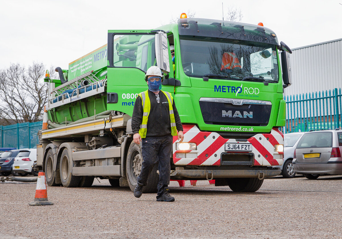 Image of a Metrorod truck on location in Norwich. A man in his vis and personal protection equipment is walking past. Taken by Norwich photographer Claire Howes.