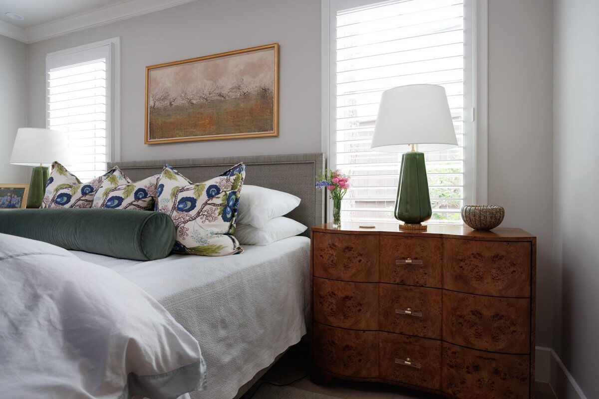 the keeping room interiors primera master bedroom with wooden bedside table and green lamp