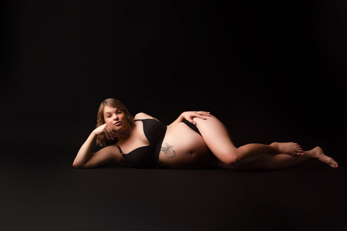 Tasteful boudoir images taken in private studio on black seamless and wearing a black shear outfit