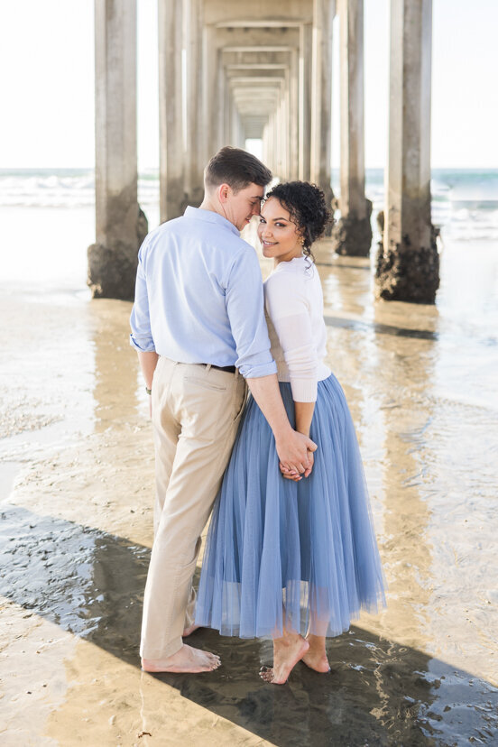 engaged-couple-under-Scripps-Pier-San-Diego
