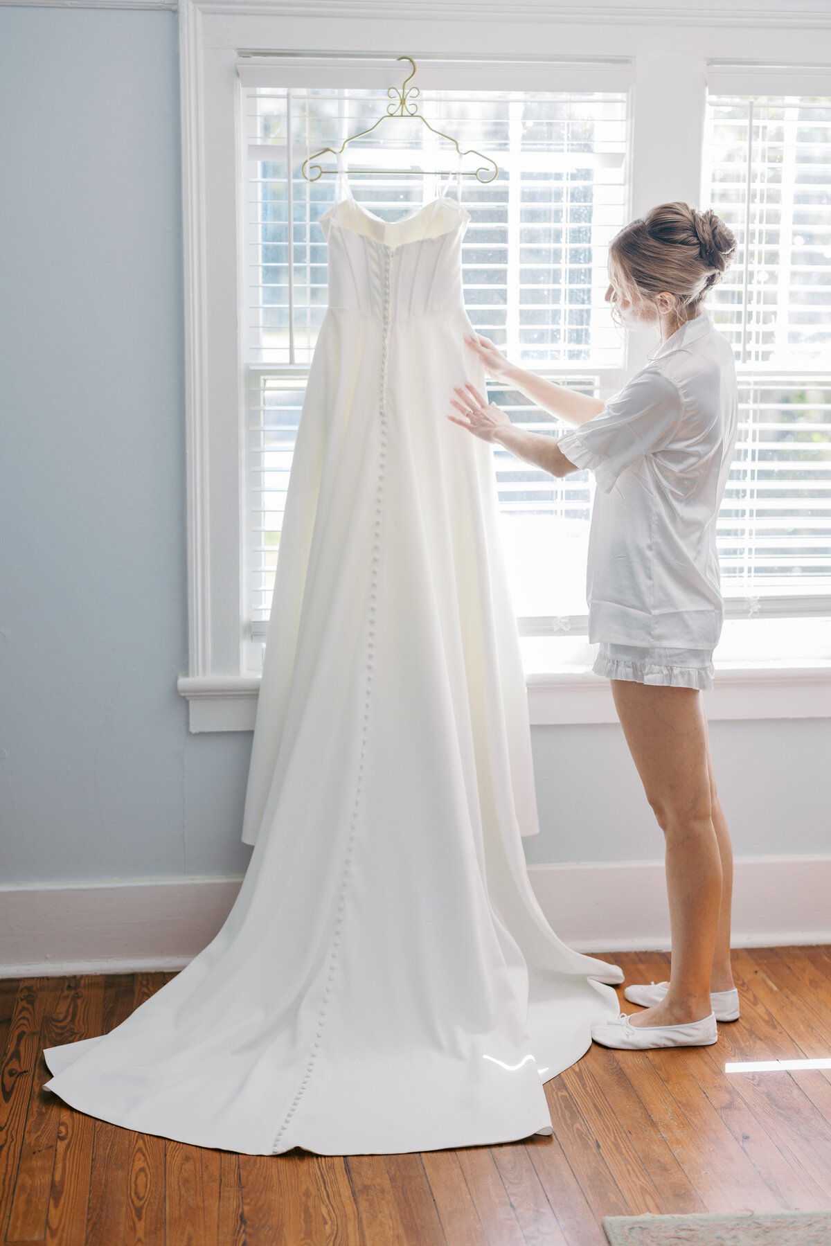 Bride looks at dress in the bridal suite at wingate place