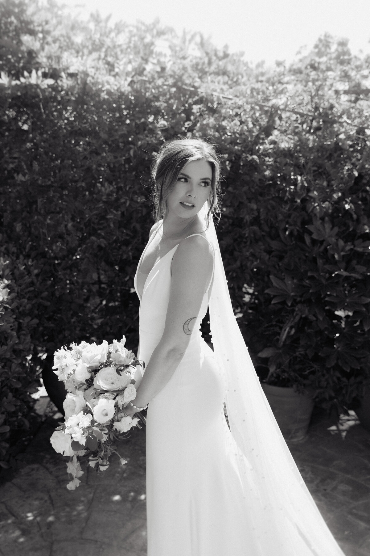 Cinematic black and white portrait of a bride with natural light, taken at a luxury wedding in La Jolla, California.