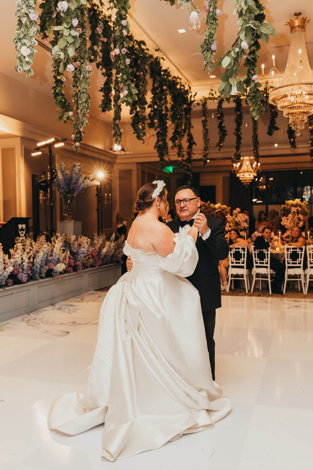dad dances with his daughter on her wedding night,.