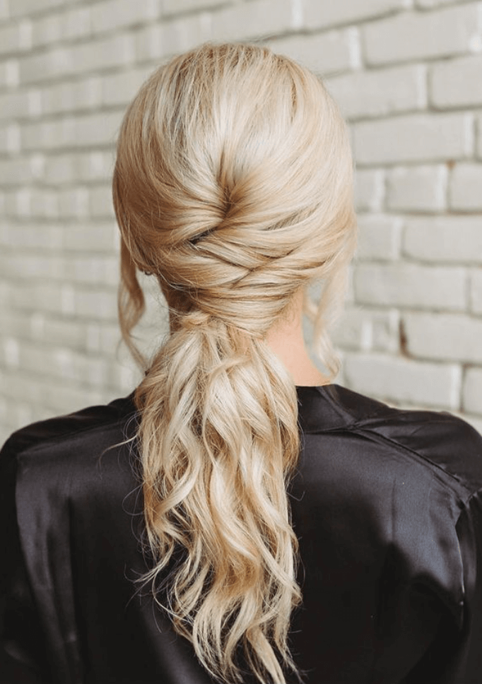 Elegant twisted low ponytail hairstyle by bridal hairdresser in Austin for wedding or special event