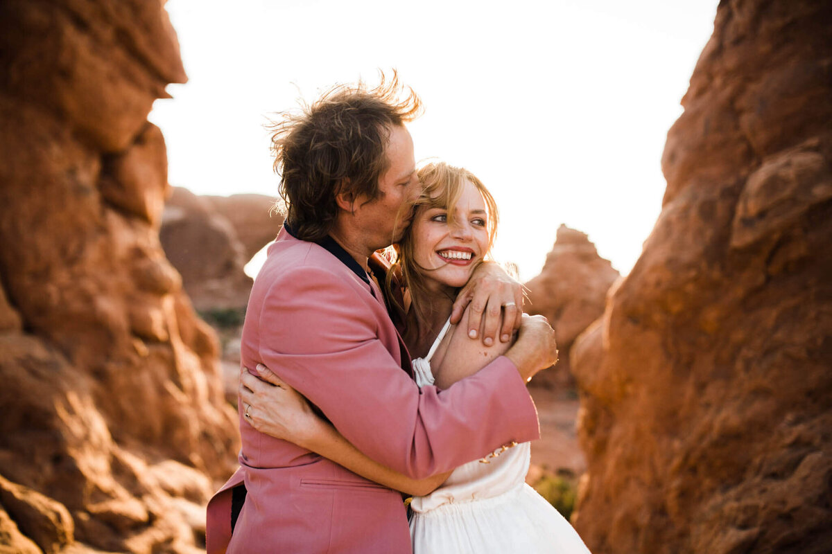 with the sky behind them the eloping couple smiles during their arizona elopement.