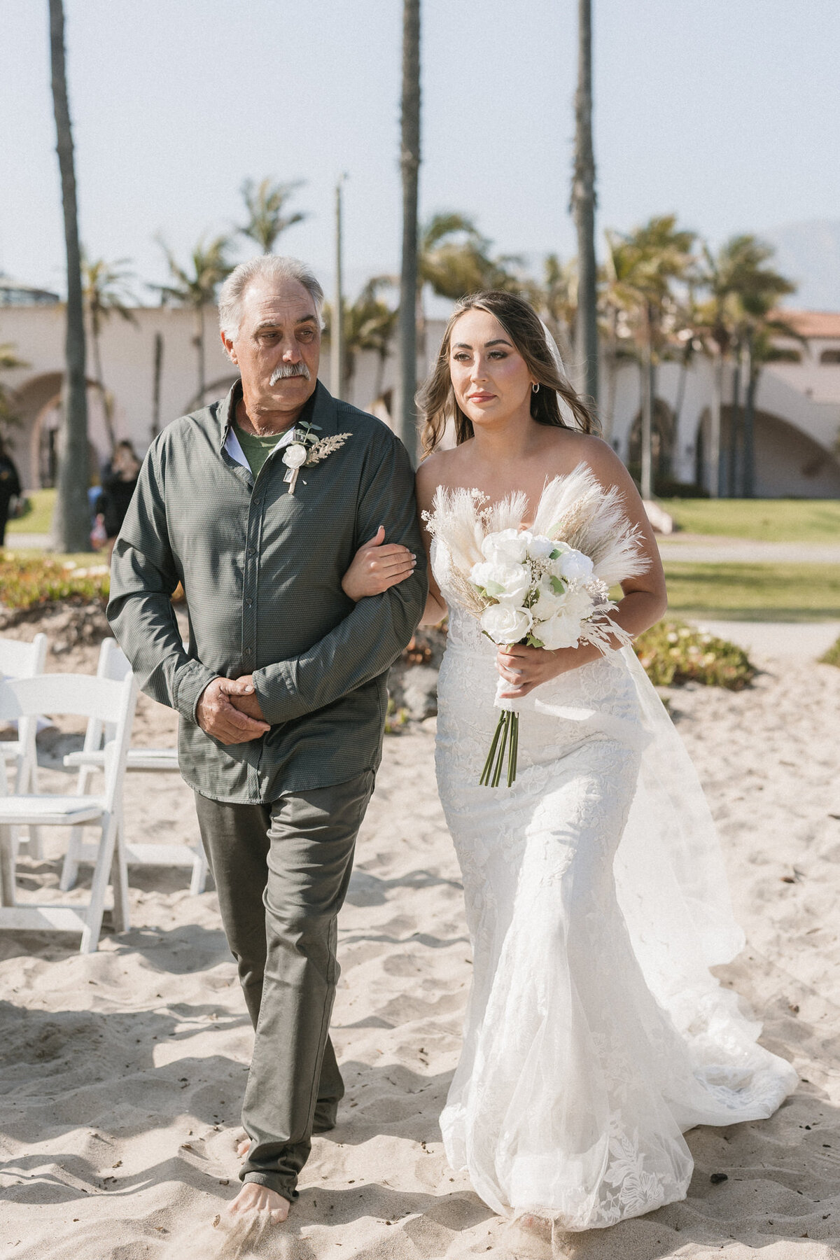 Bride and dad walking down aisle on beach at ceremony at Hilton Beachfront Resort Santa Barbara