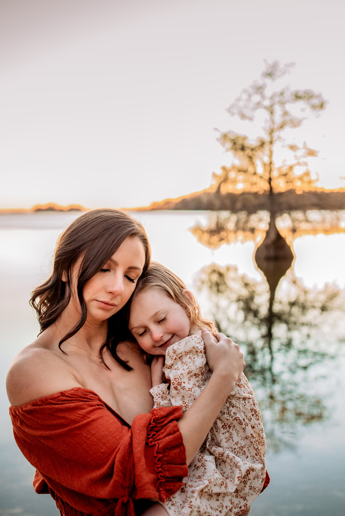 mom holding her baby, cuddles , mom and daughter ,