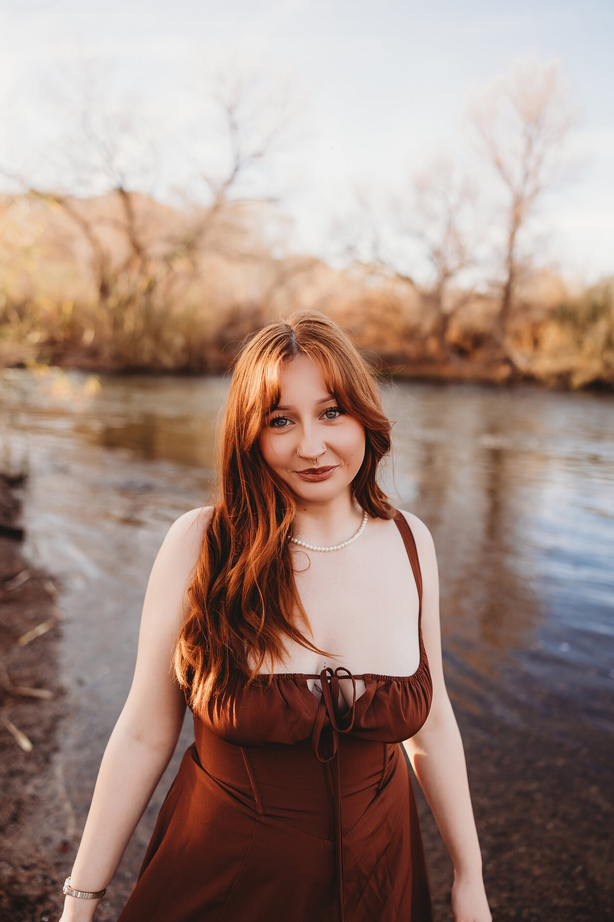 Girl with red hair posing at salt river for senior session by phoenix photographer