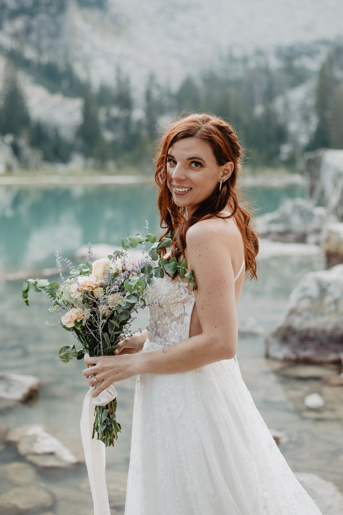Jackson Hole Photographers capture bride holding bouquet and smiling