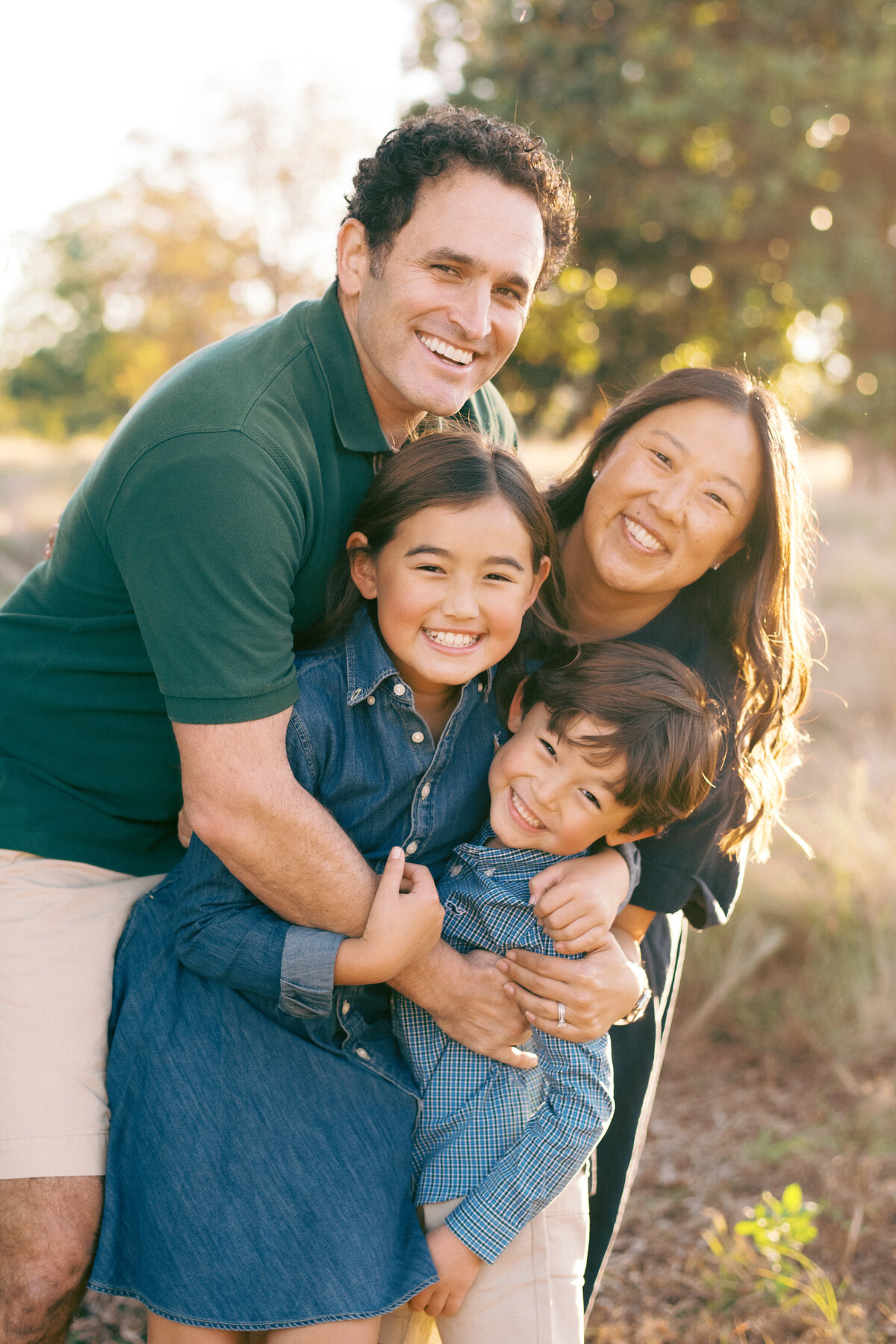 Family laughs at the camera during this fall session in Raleigh NC. Image by Raleigh maternity photographer A.J. Dunlap Photography.