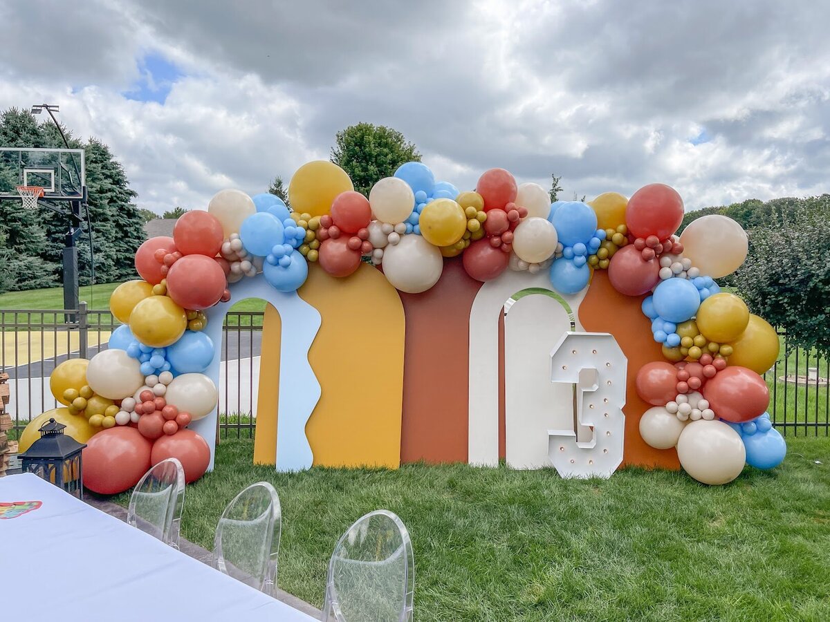 Bright and bold balloons attached to wooden backdrops