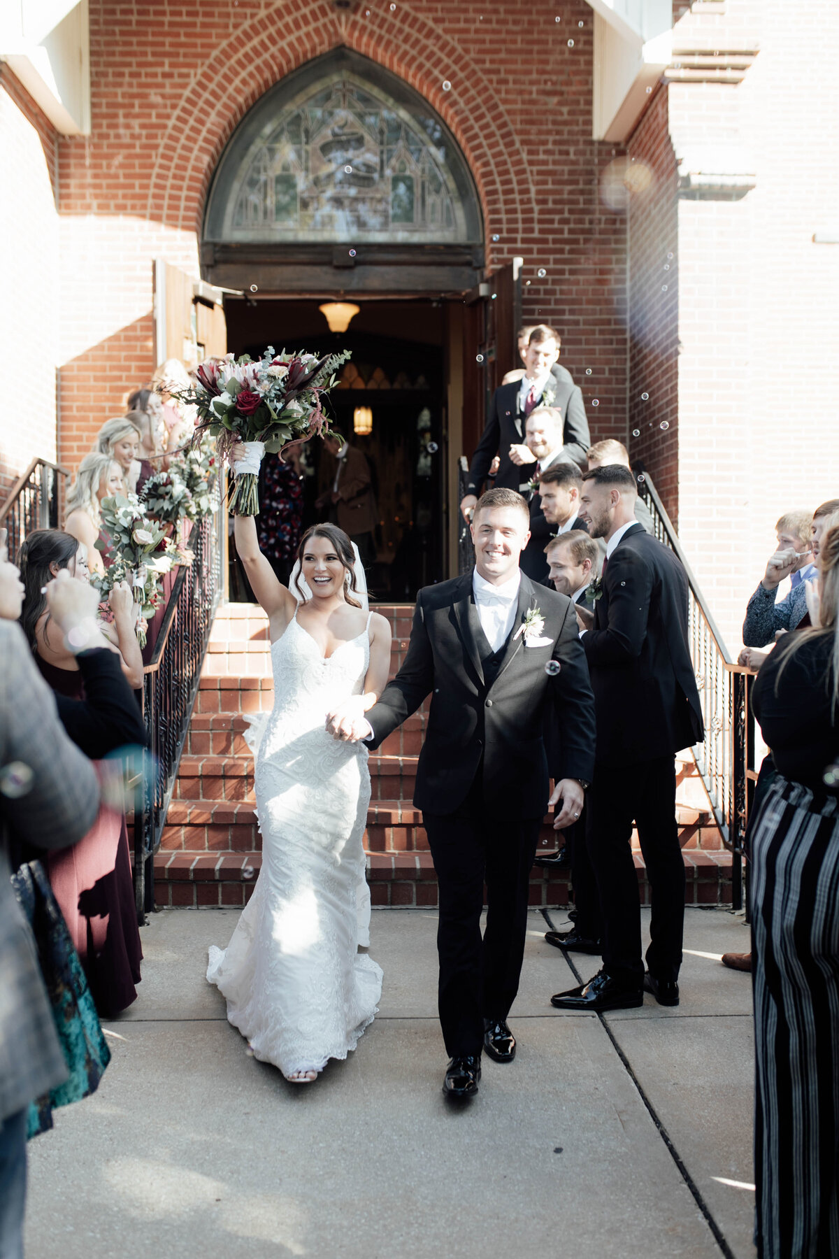 Bride and groom walking out of church. 