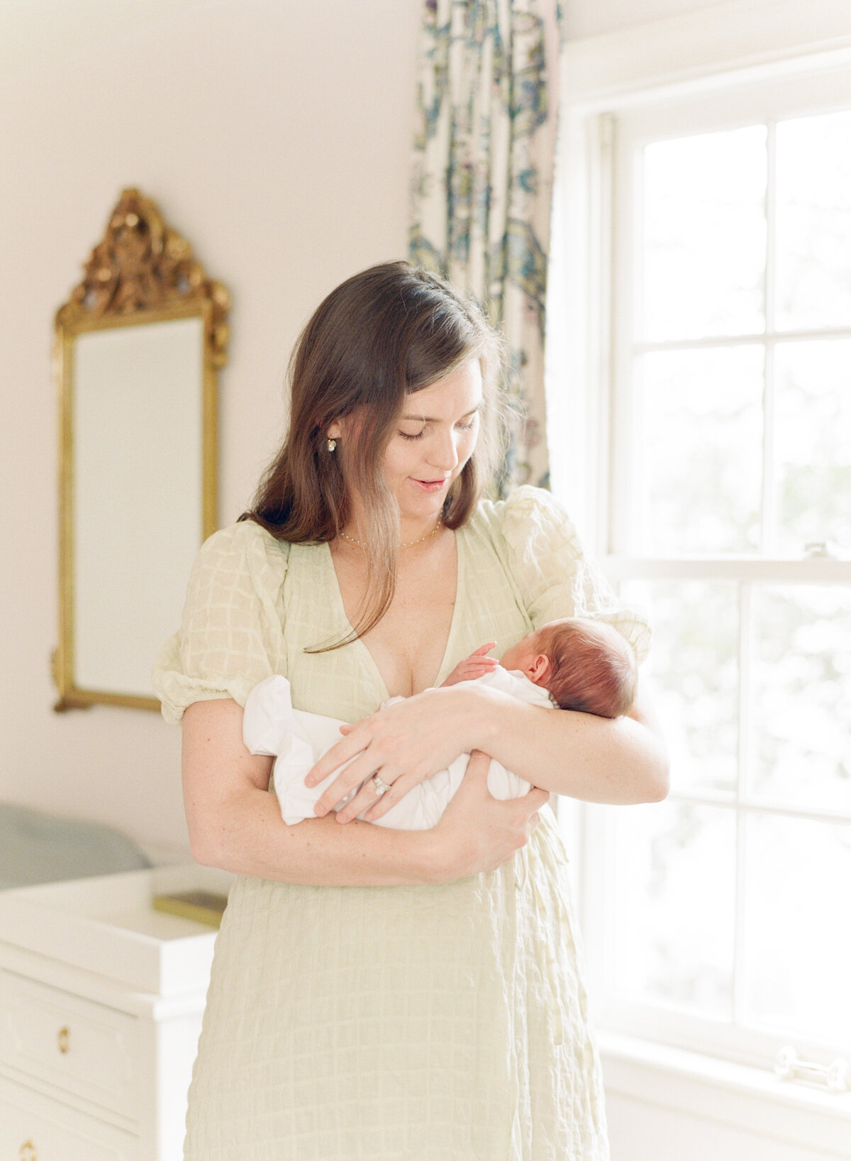 New mom holds her daughter for a Charlotte NC newborn session. Image by Raleigh newborn photographer A.J. Dunlap Photography.