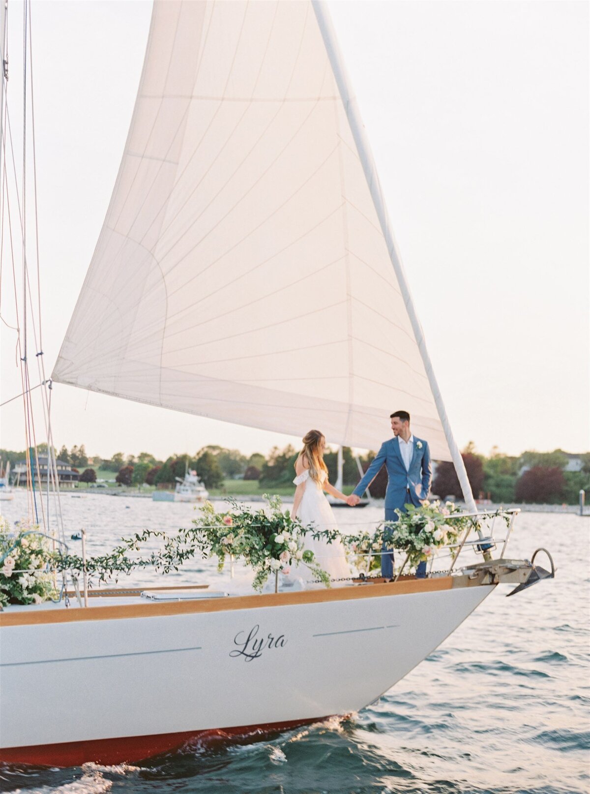 Kate-Murtaugh-Events-RI-wedding-planner-coastal-Newport-luxury-elopement-floral-installation-sailboat-yacht-sail-RI-couple-holding-hands