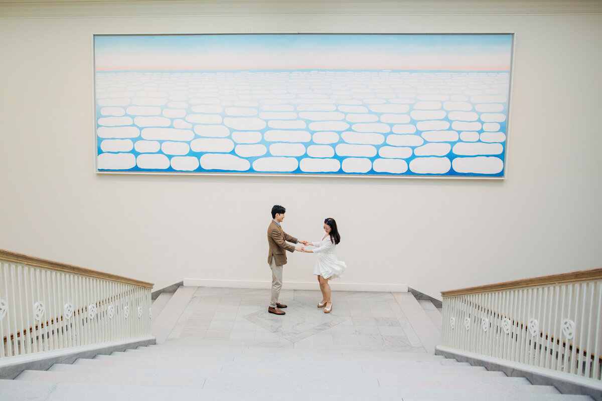 A couple dances in front of Georgia O'Keeffe's Sky Above Clouds hanging at the Art Institute in Chicago