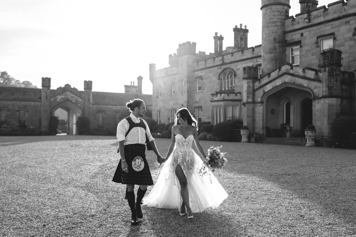 bride and groom walking scottish castle