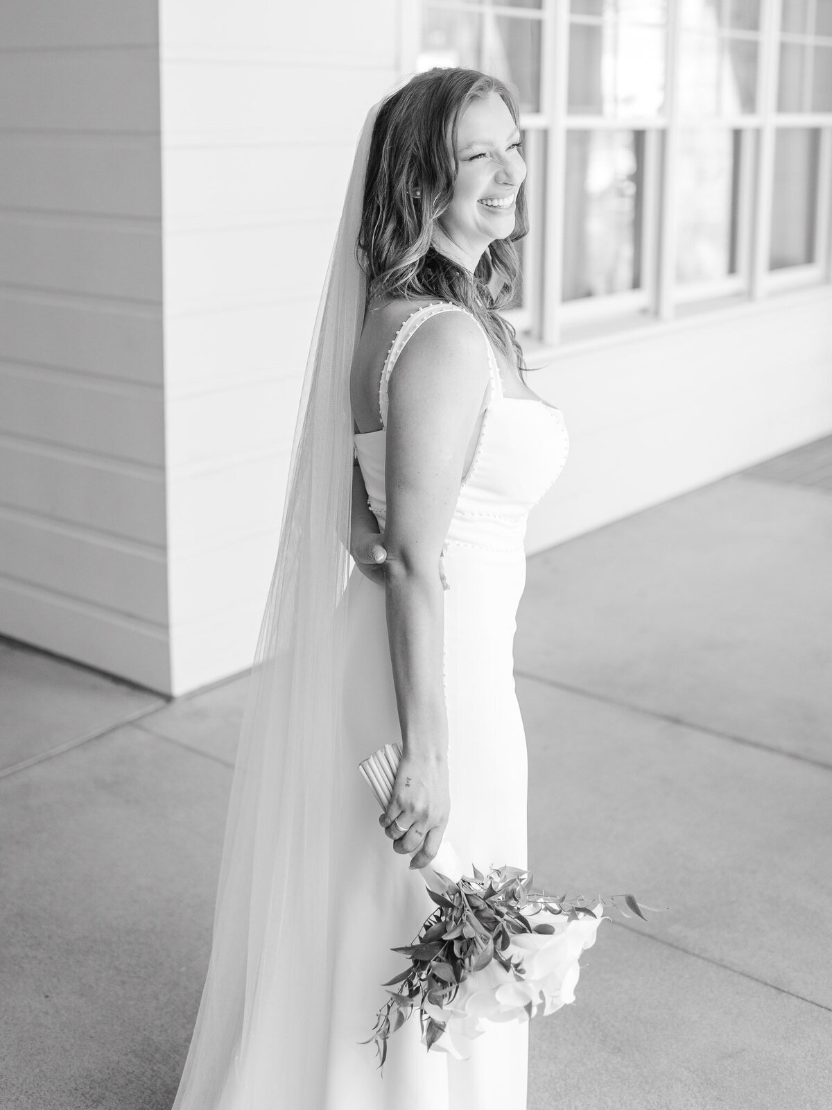 Black and white portrait of a bride smiling with soft natural light at Lido House
