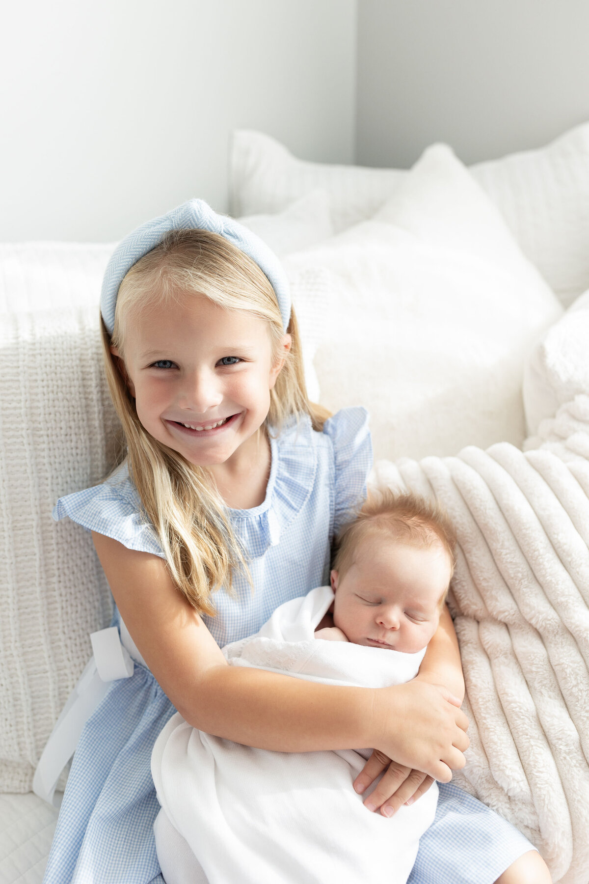 Big sister holding baby