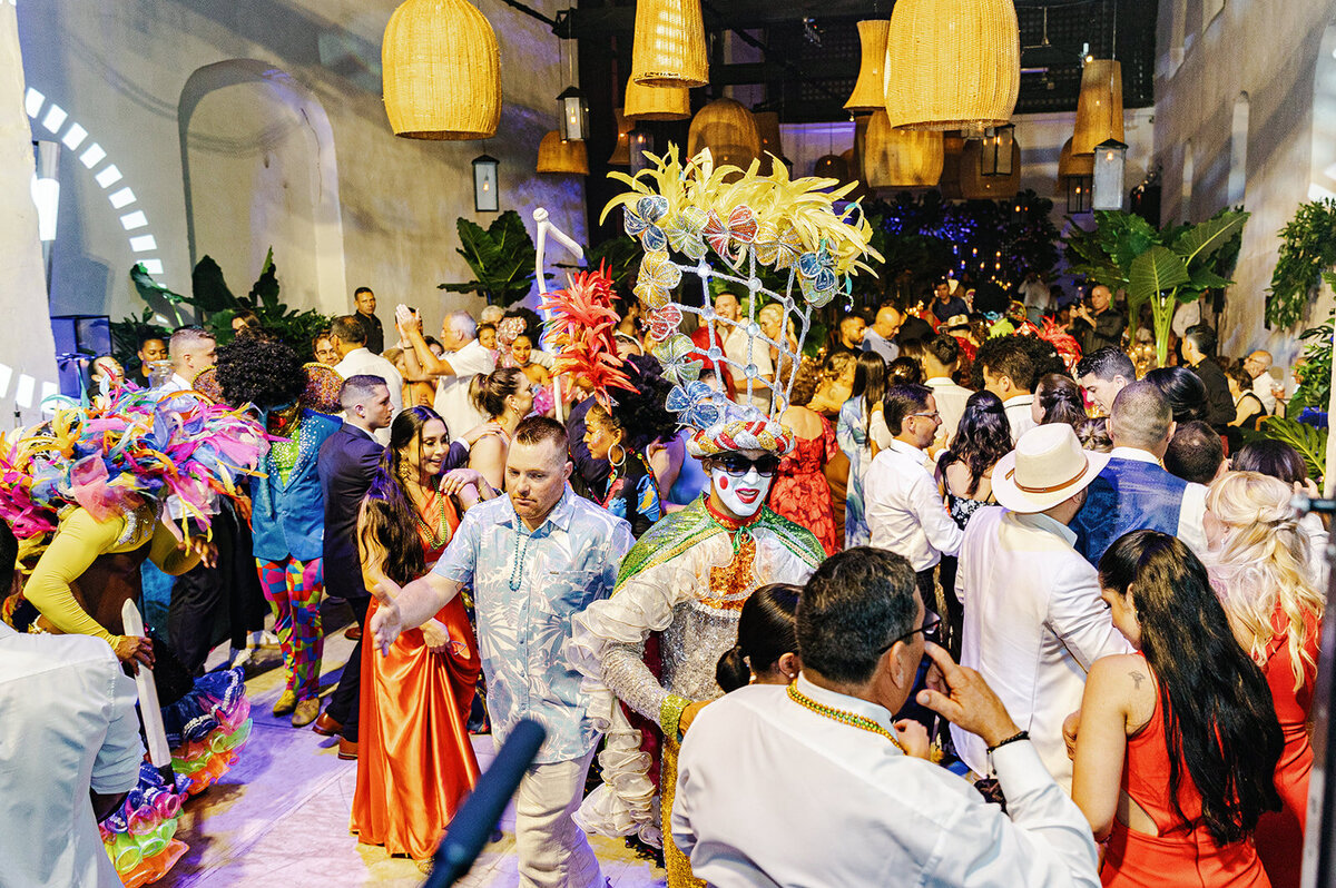 A festive moment as Victoria and Daniel join traditional Colombian performers in a lively wedding celebration.