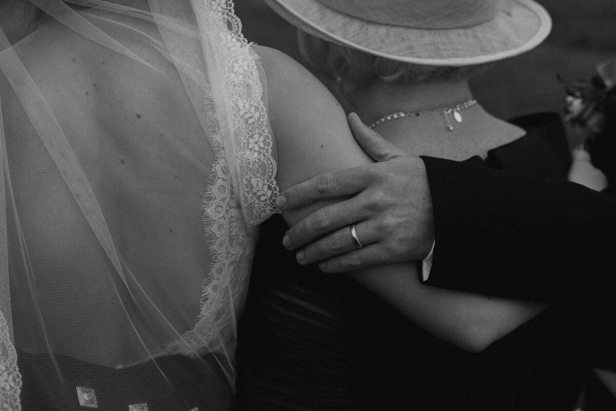 hand on bride's arm during photo