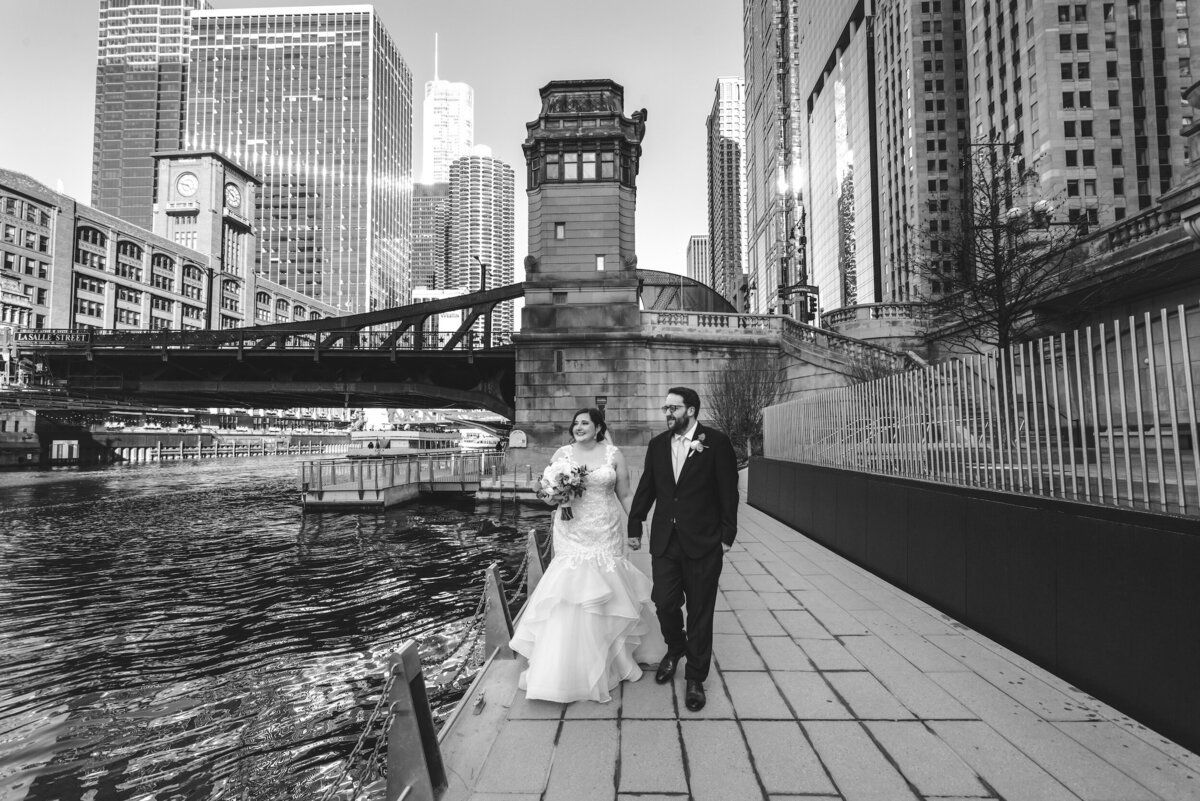 Bride and groom walk on the Chicago Riverwalk