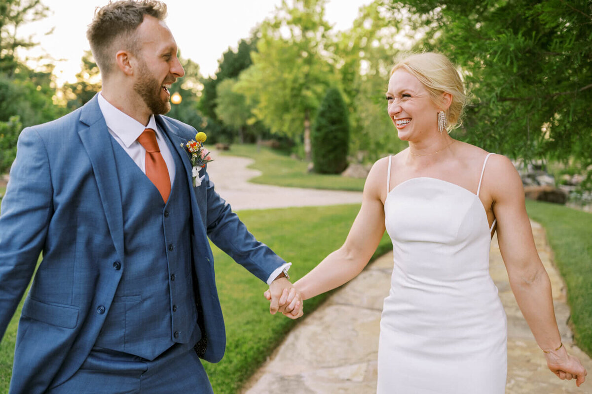 couple-laughing-holding-hands-and-walking