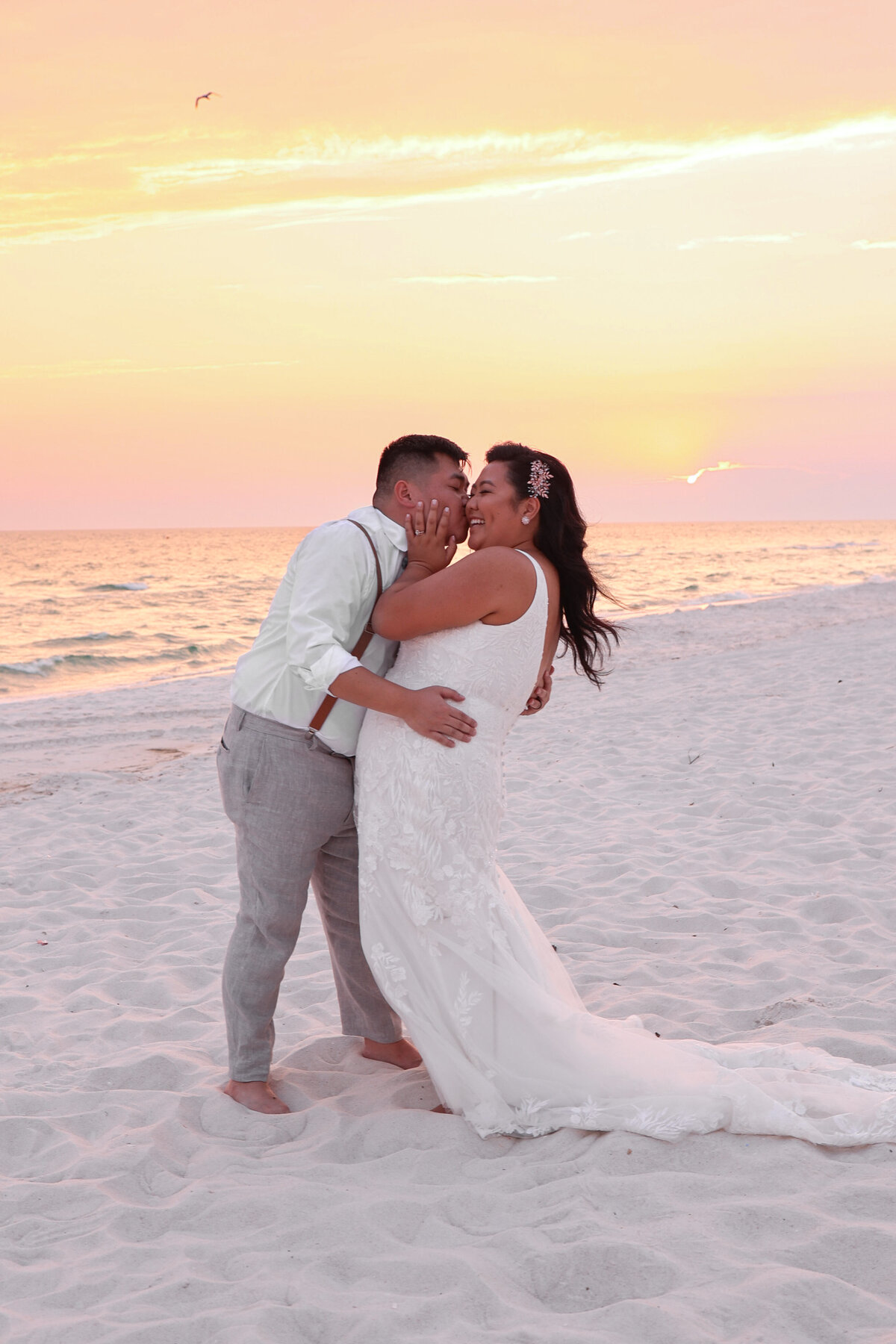 bride and groom being playful at sunset in Panama  City Beach by Florida Wedding Photographer Amanda Richardson Photography