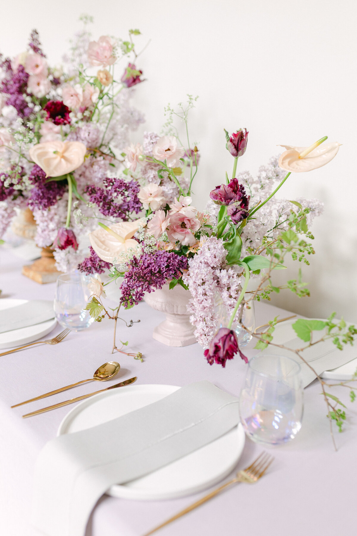 Airy centrepieces of lilacs and spring flowers decorates a table at a Montreal wedding. 