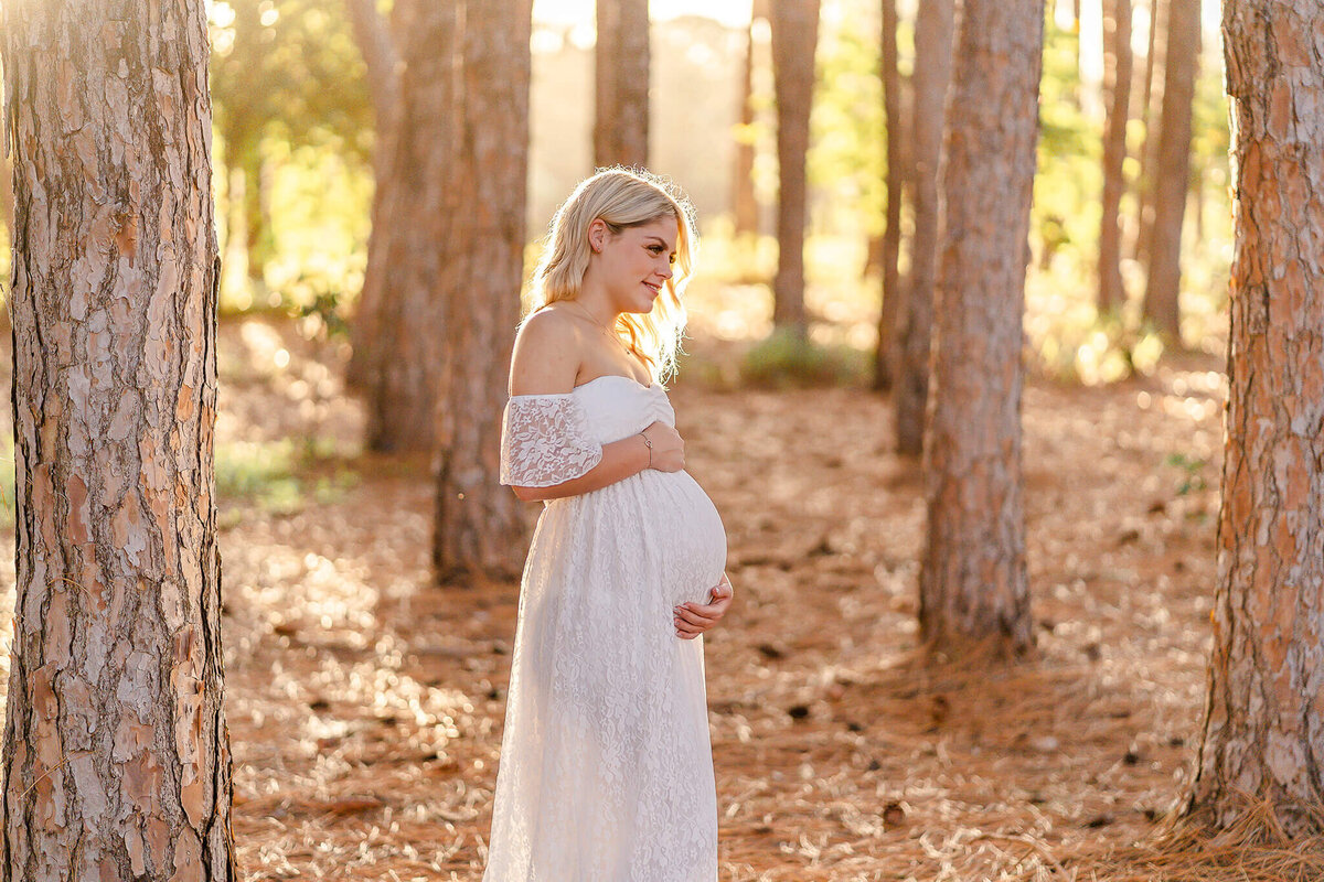 blonde girl in white lace dress having maternity photos taken by hikari lifestyle photography maternity photographer