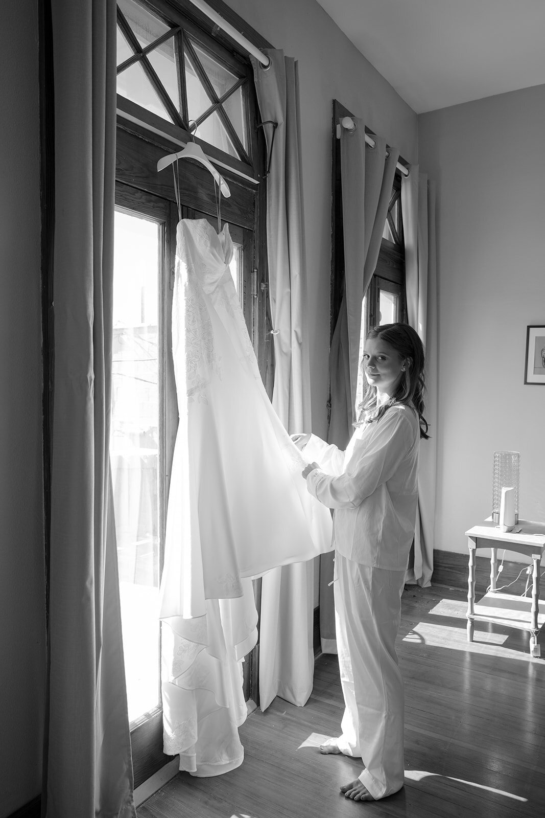 Cinematic editorial image of bride reflected in window with wedding gown at San Antonio estate