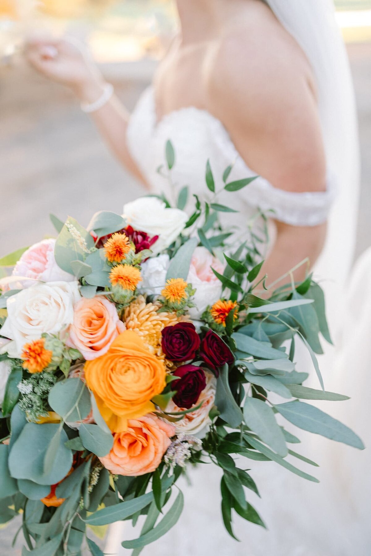 Bride holding floral arrangement at farm wedding near Charlottesville VA