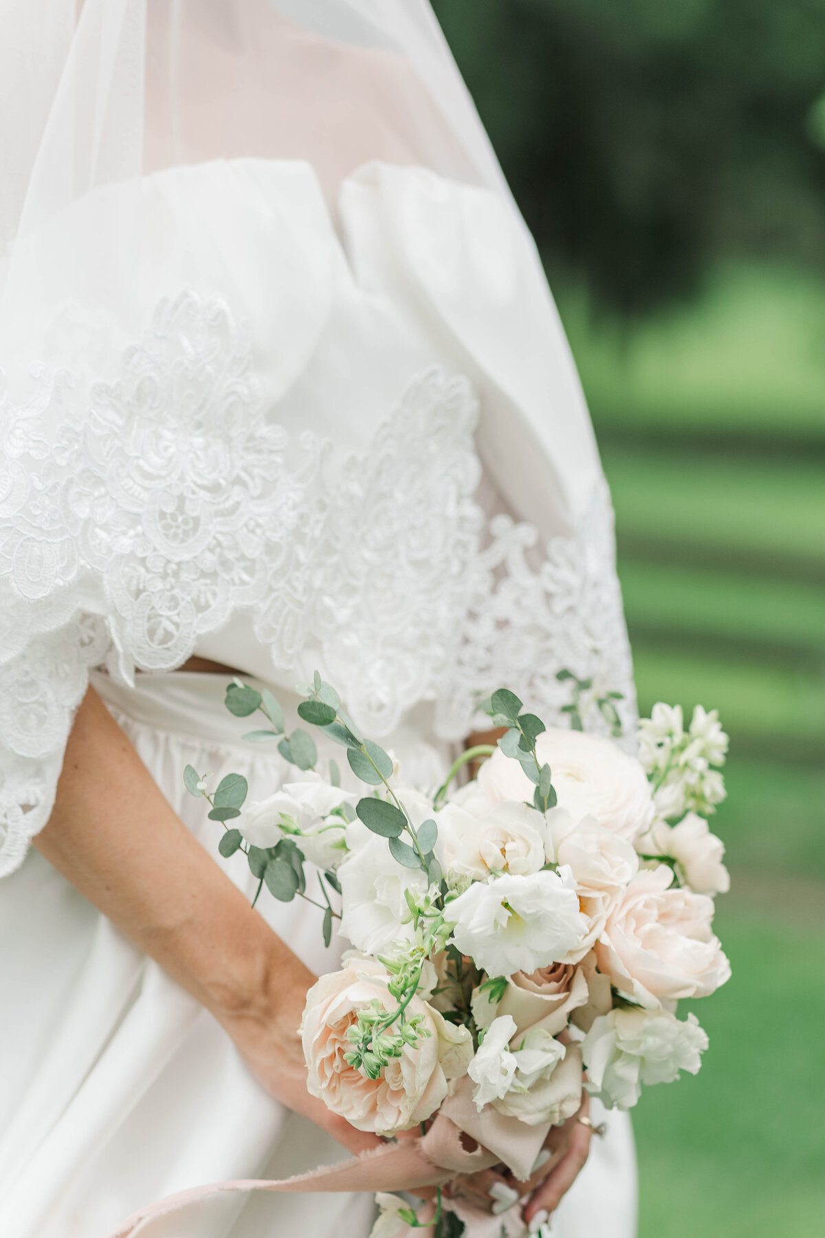 detail of wedding bbouquete made of white and soft pink flowers