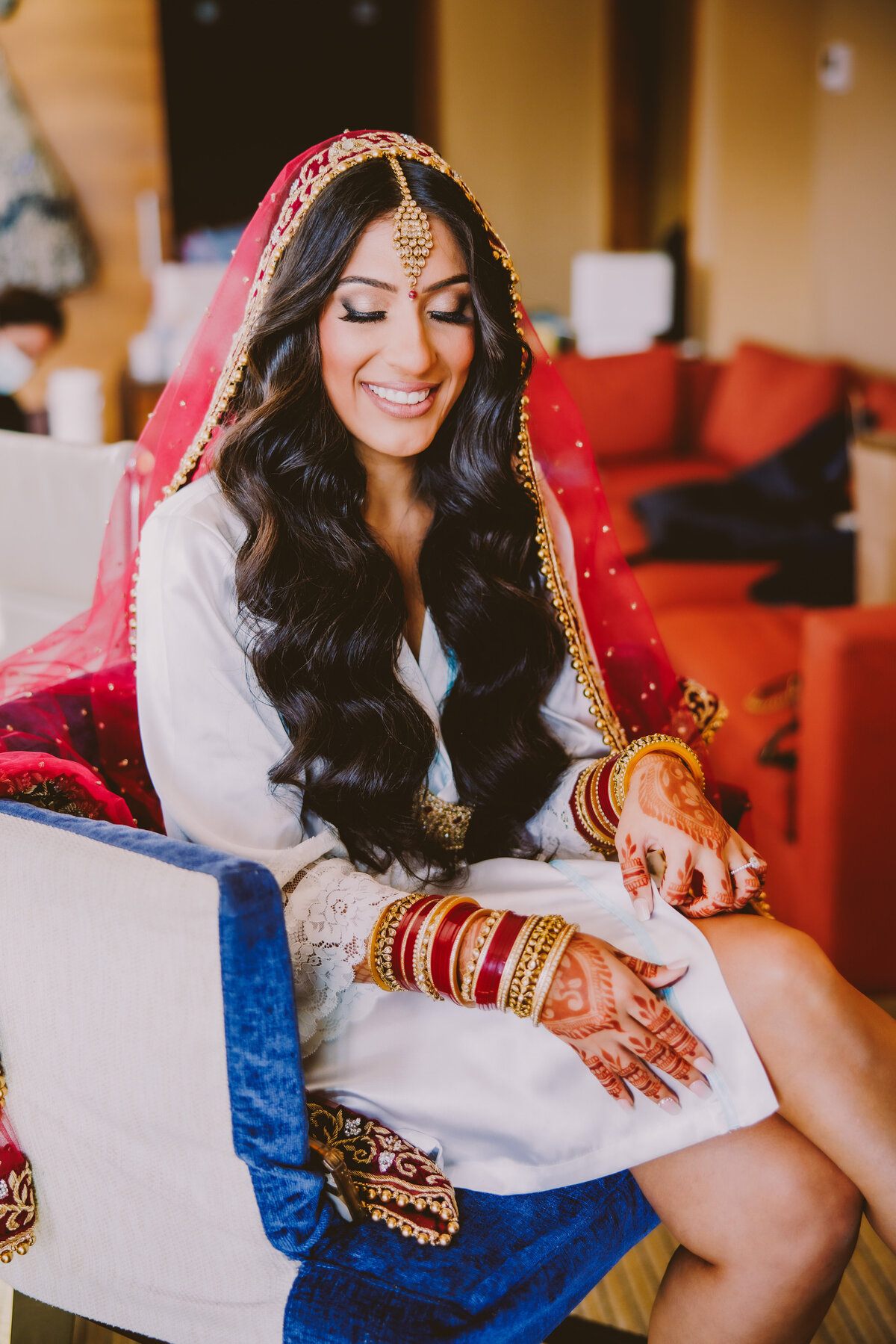 An indian bride getting ready during her bridal prep on the wedding day at the jersey city hyatt in nj