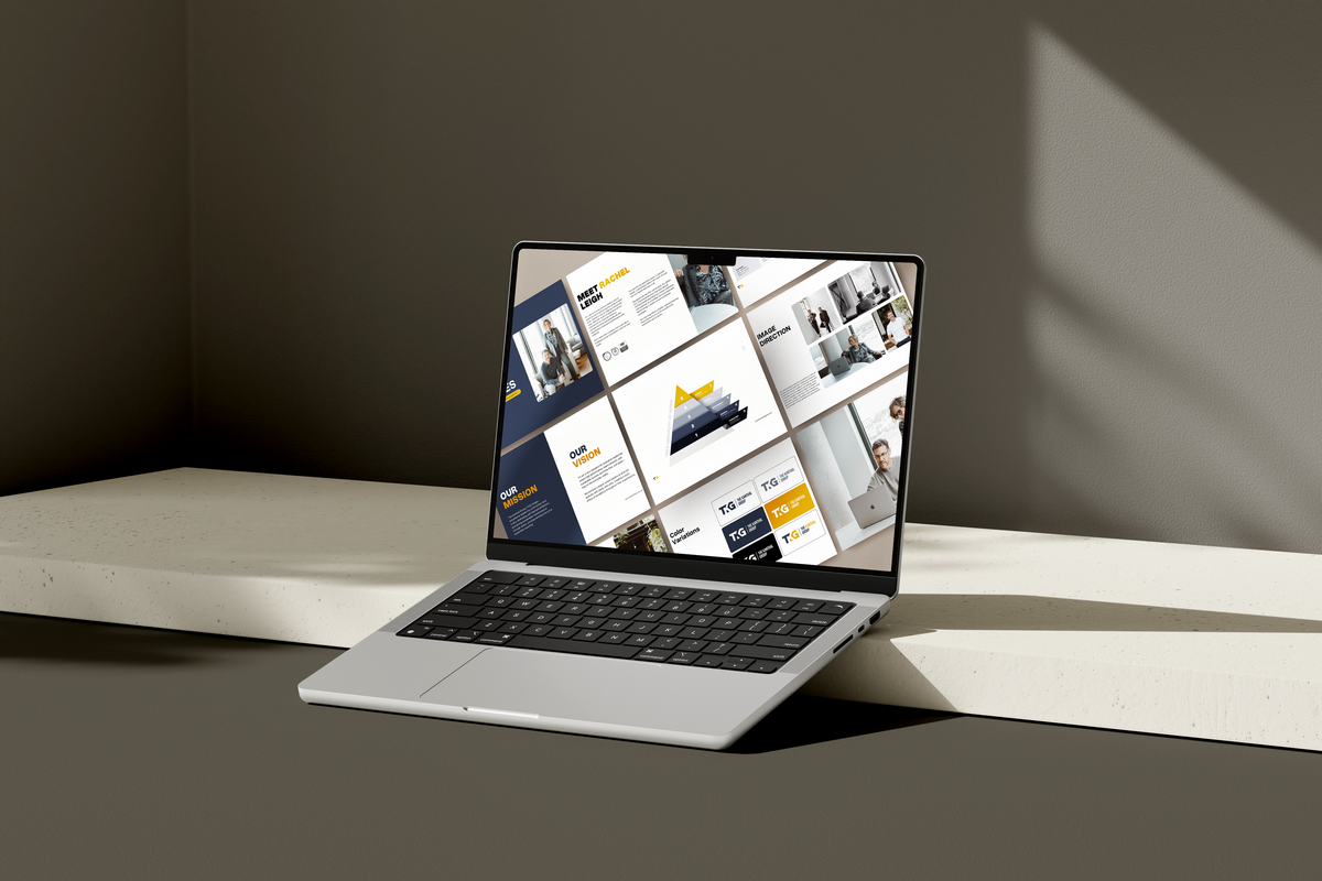 Laptop mockup showcasing a brand identity design in blue, white and gold for an executive coaching firm on a dark grey background.