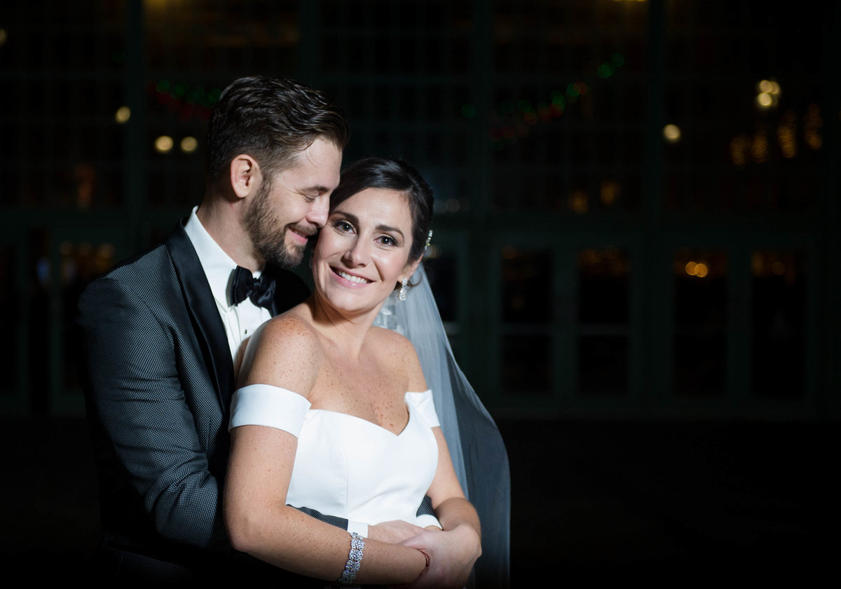 night time portraits og bride and groom on boardwalk