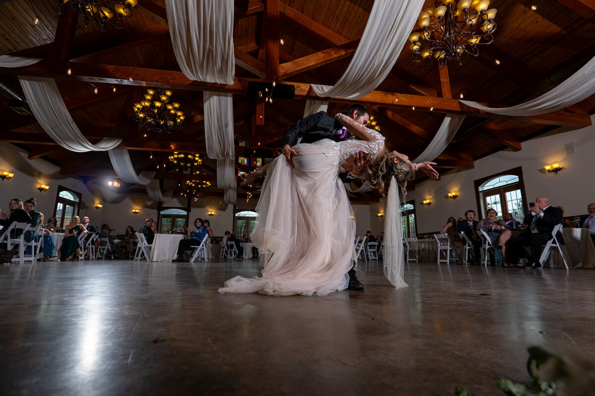 a person dipping their partner during their first dance 