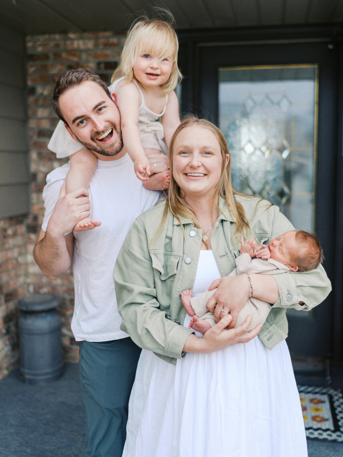family-smiling-together-front-porch