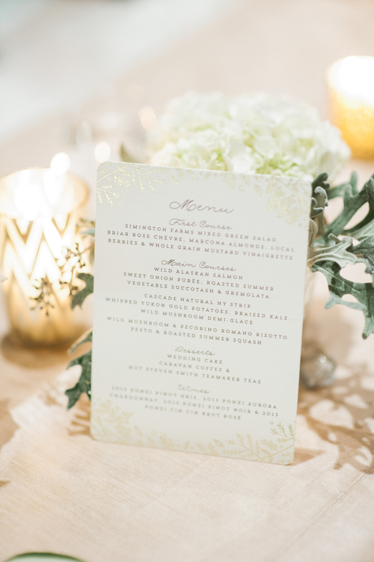 dinner menu on candle lit table with blush flowers at ponzi winery