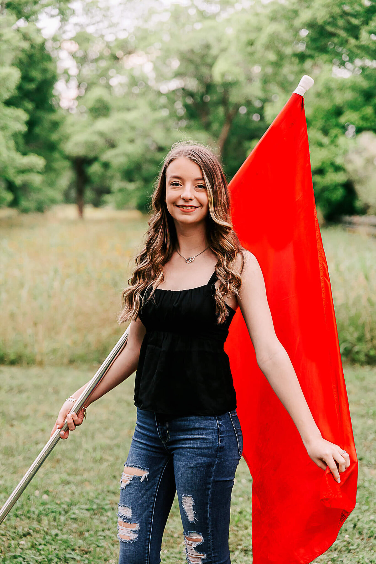 Graduate with her color guard flag