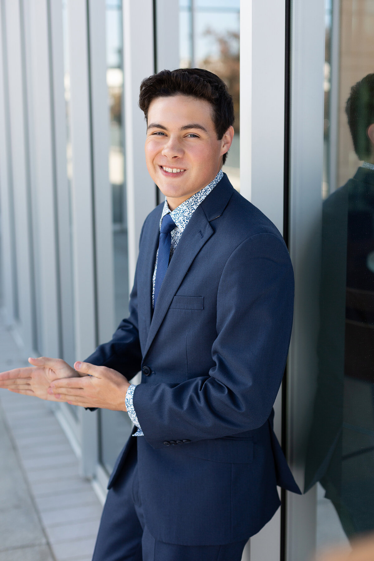 Senior Guy Photos in front of a glass wall