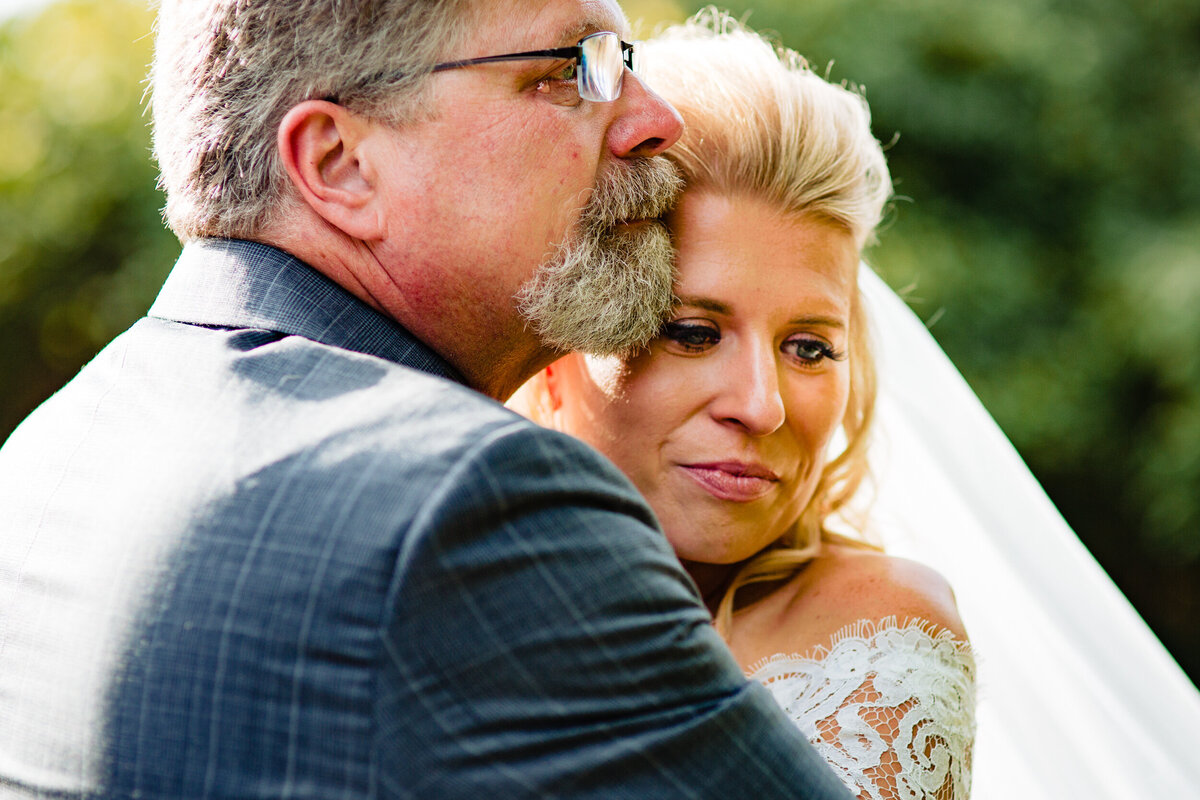 One of the top wedding photos of 2020. Taken by Adore Wedding Photography- Toledo, Ohio Wedding Photographers. This photo is of a bride and her crying father during their emotional first look at the Toledo Zoo