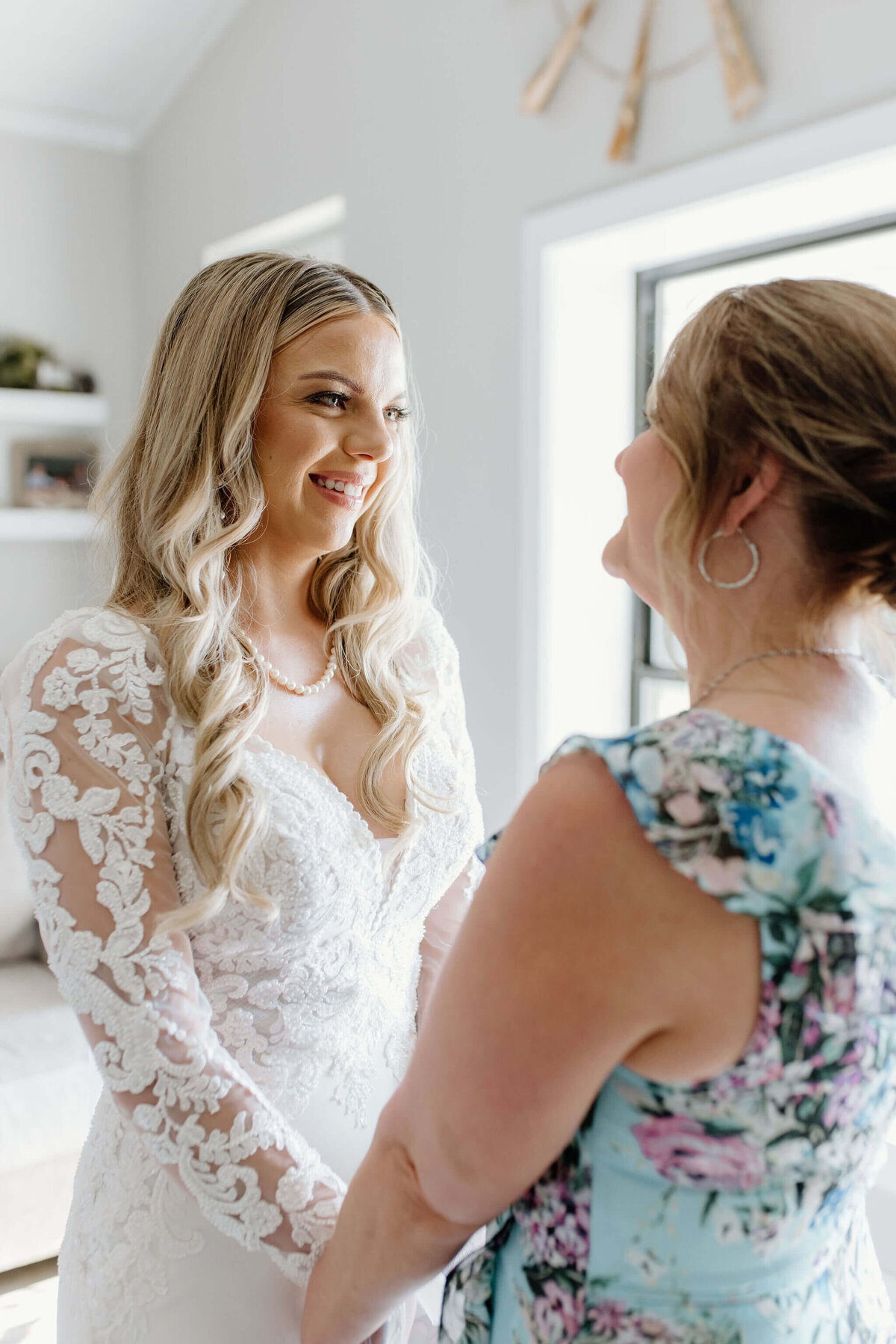 mother of the bride and bride sharing sweet intimate moment prior to wedding ceremony