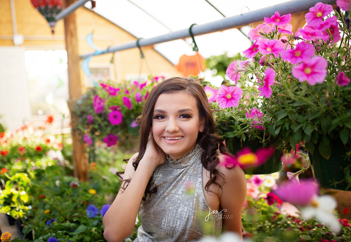 Senior girl in greenhouse full of flowers Tulia tx