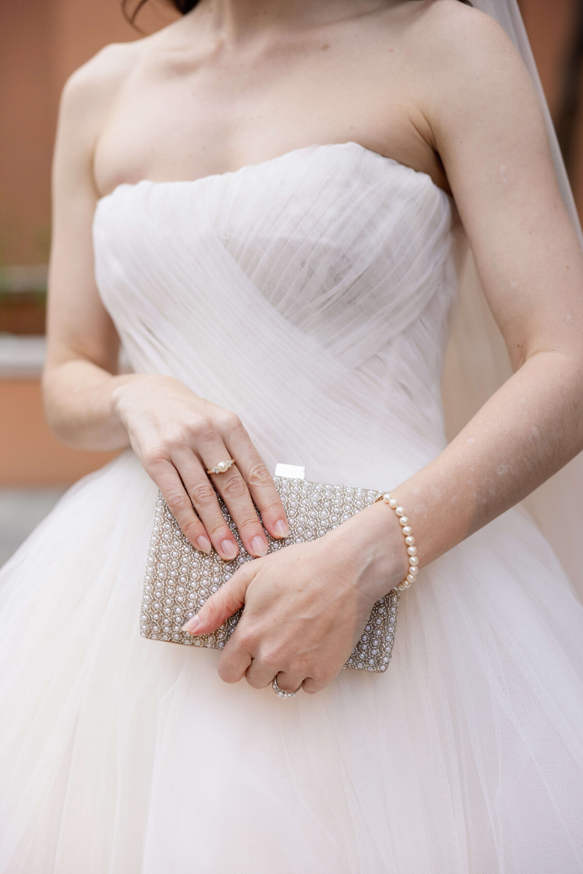 Detail of a bride holding a silver rhinestone purse