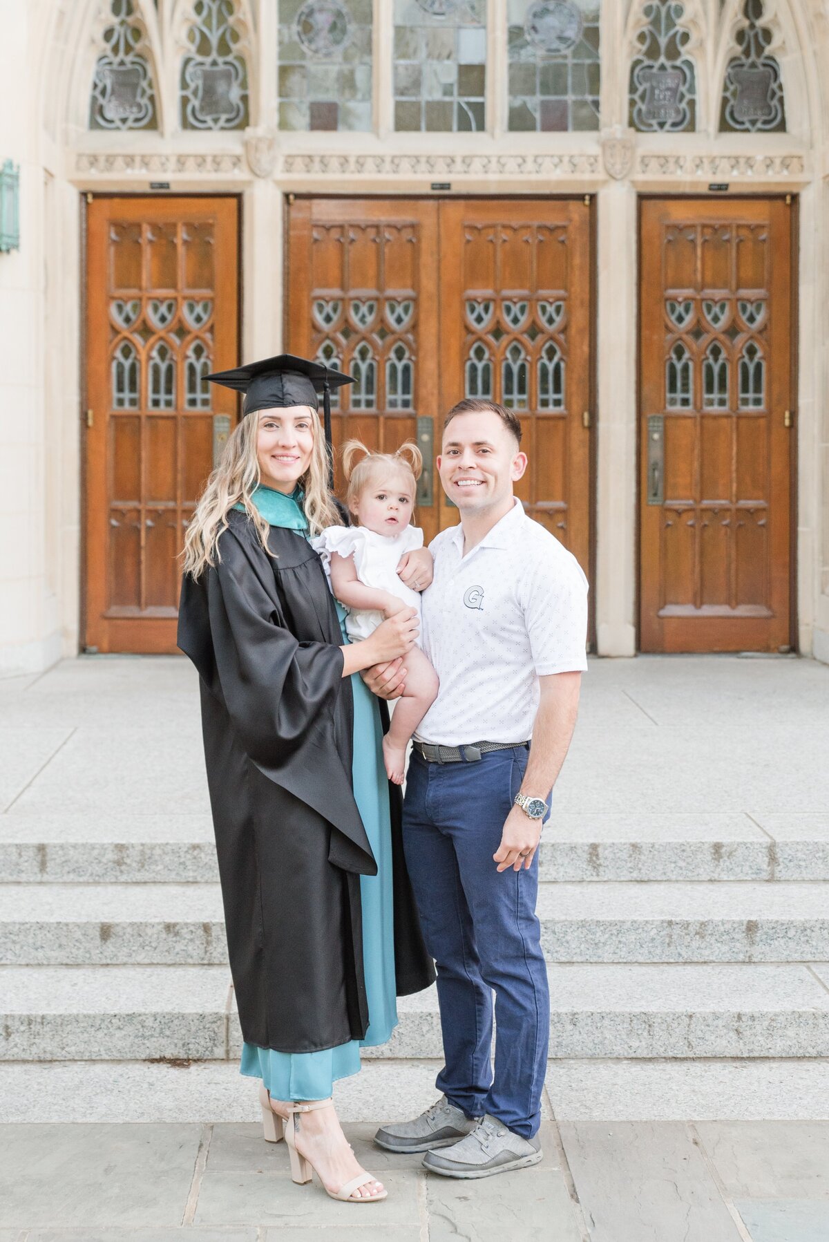 female graduate with family in regalia