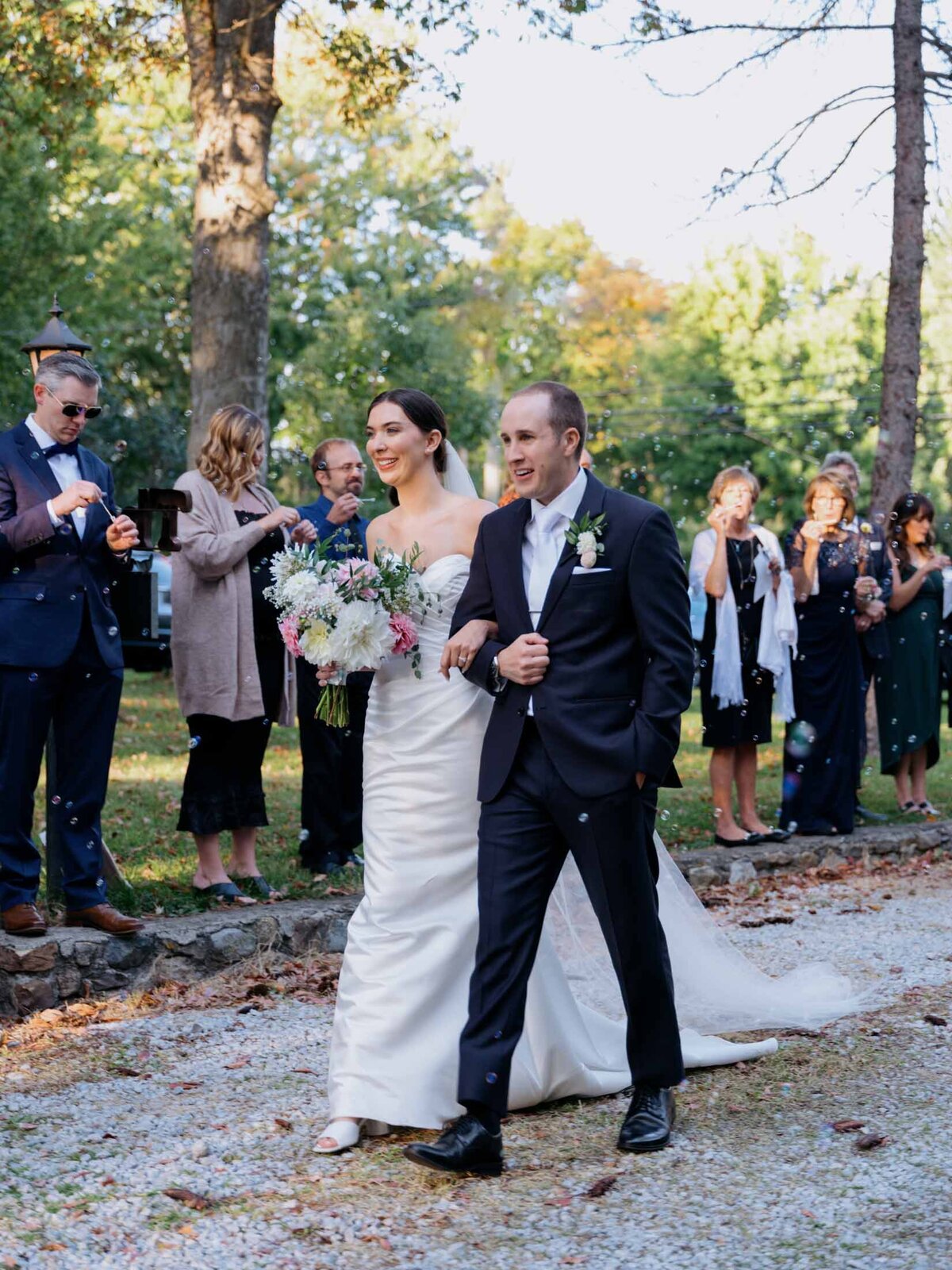 Couple greeted by guests at their ceremony exit.